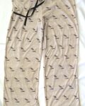 Women's beige pajama pants with a repeated pattern of sandpiper birds.
